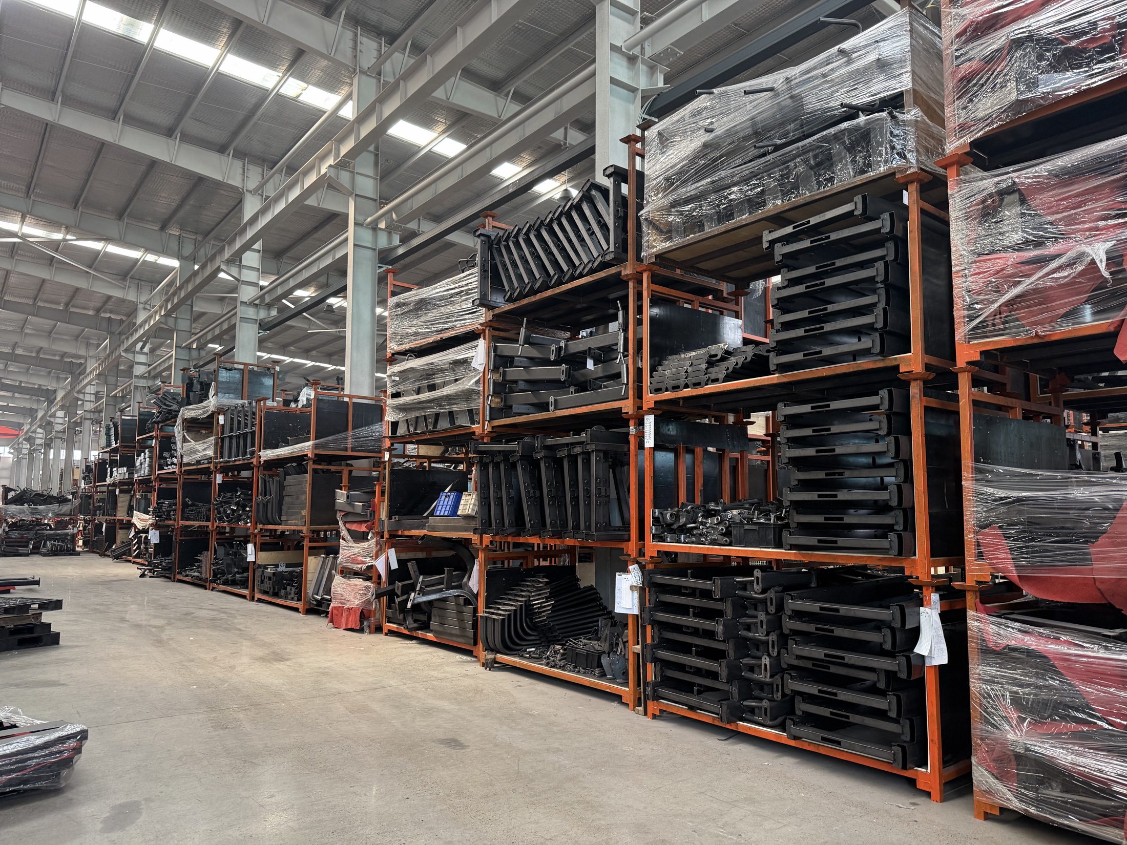 Organized fitness equipment components inside the factory
