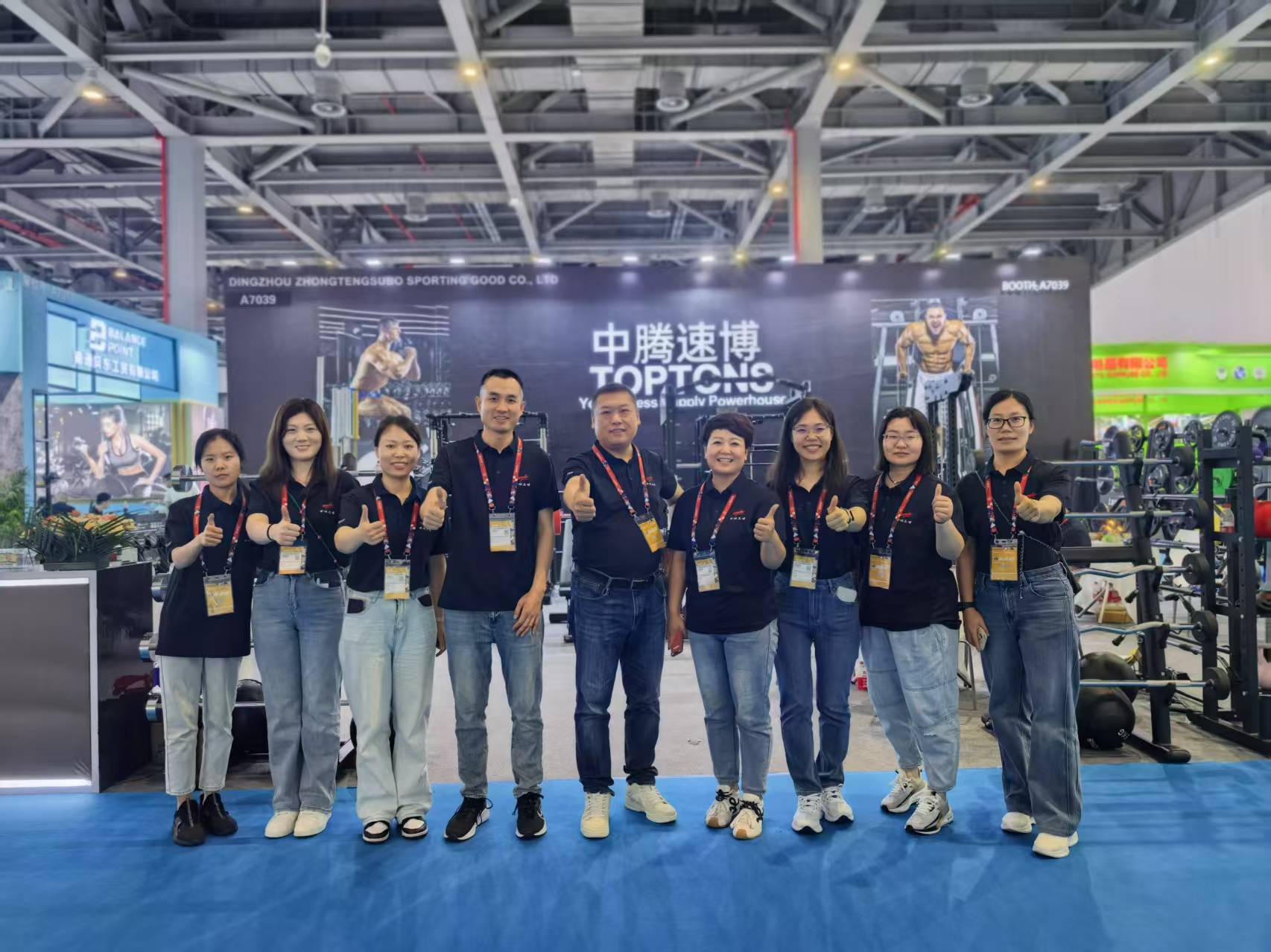 TOPTONS exhibition team in front of the company booth